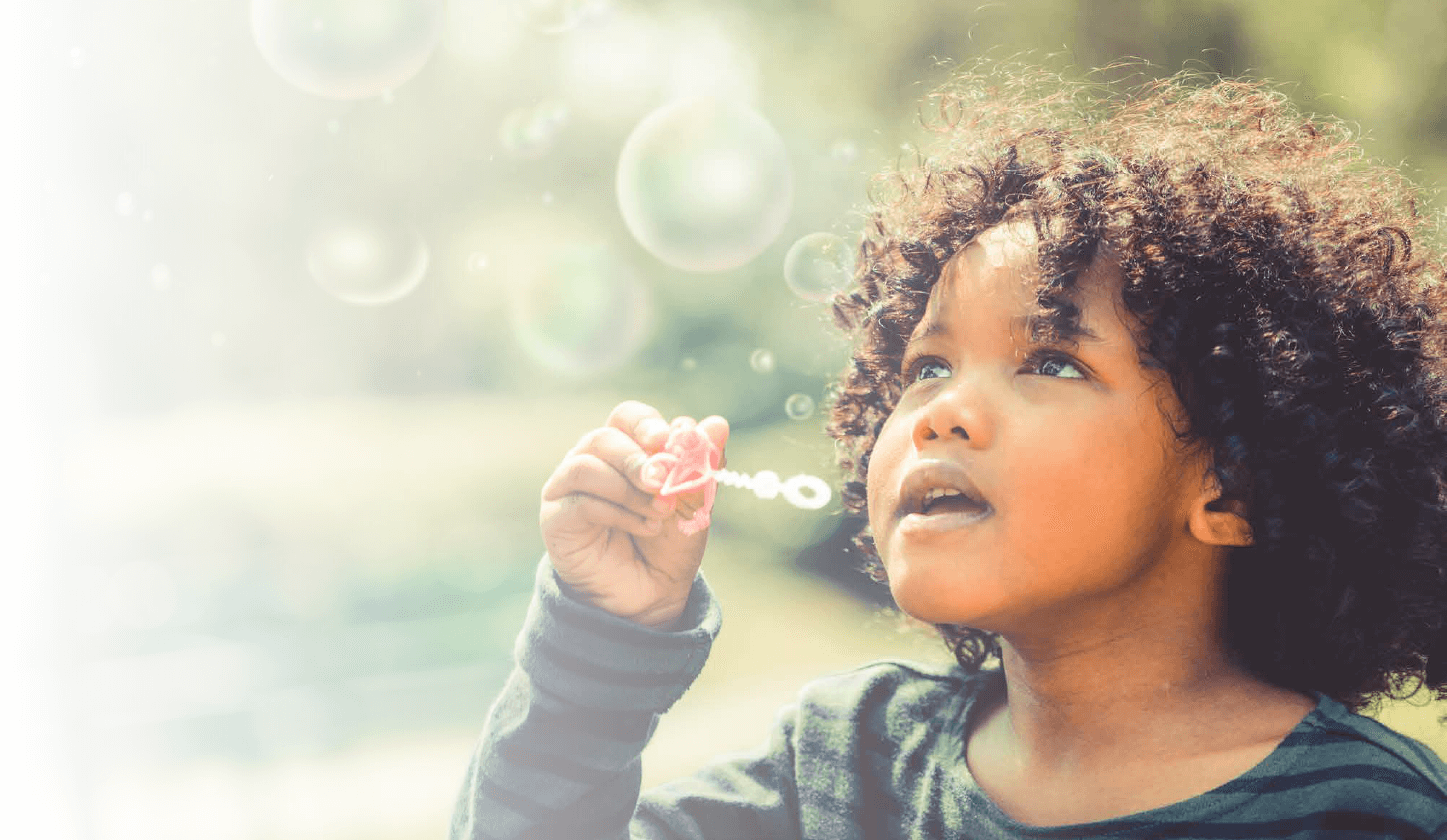 girl blowing bubbles